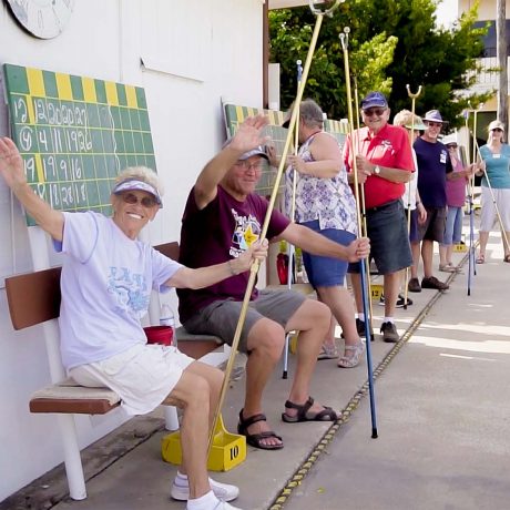 Happy residents playing shuffleboard