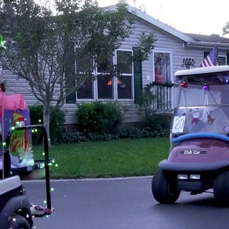 two golf carts with holiday decorations