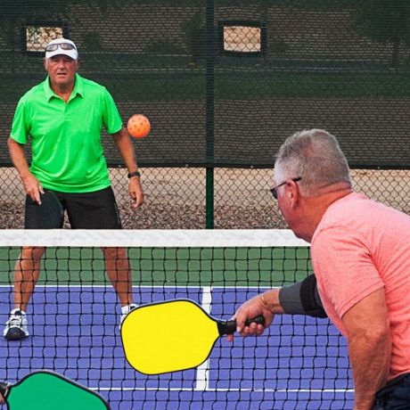 four players in a game of pickleball
